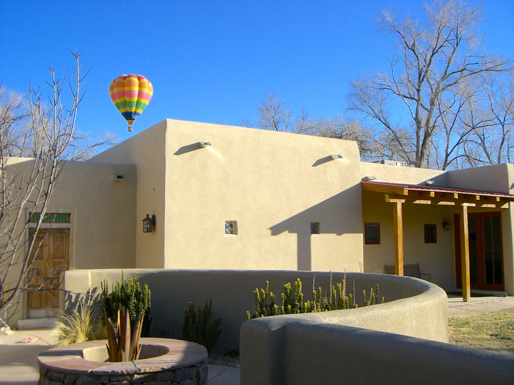 Southwestern Stucco Addition with Exposed Beam Patio Cover, Antique Gate, Moss Rock Fire Pit, Hot Air Balloon