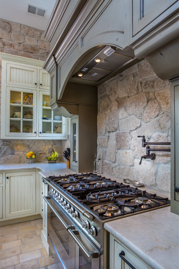 Award-Winning Farmhouse Kitchen - Custom Grey and Cream Distressed Cabinets, Stone Backsplash, Stainless Range, Potfiller, French Limestone Floor